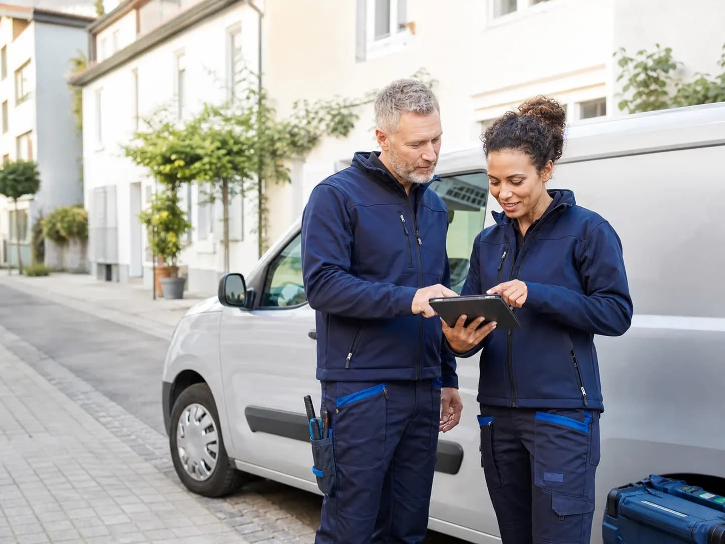 Two service professionals reviewing work
